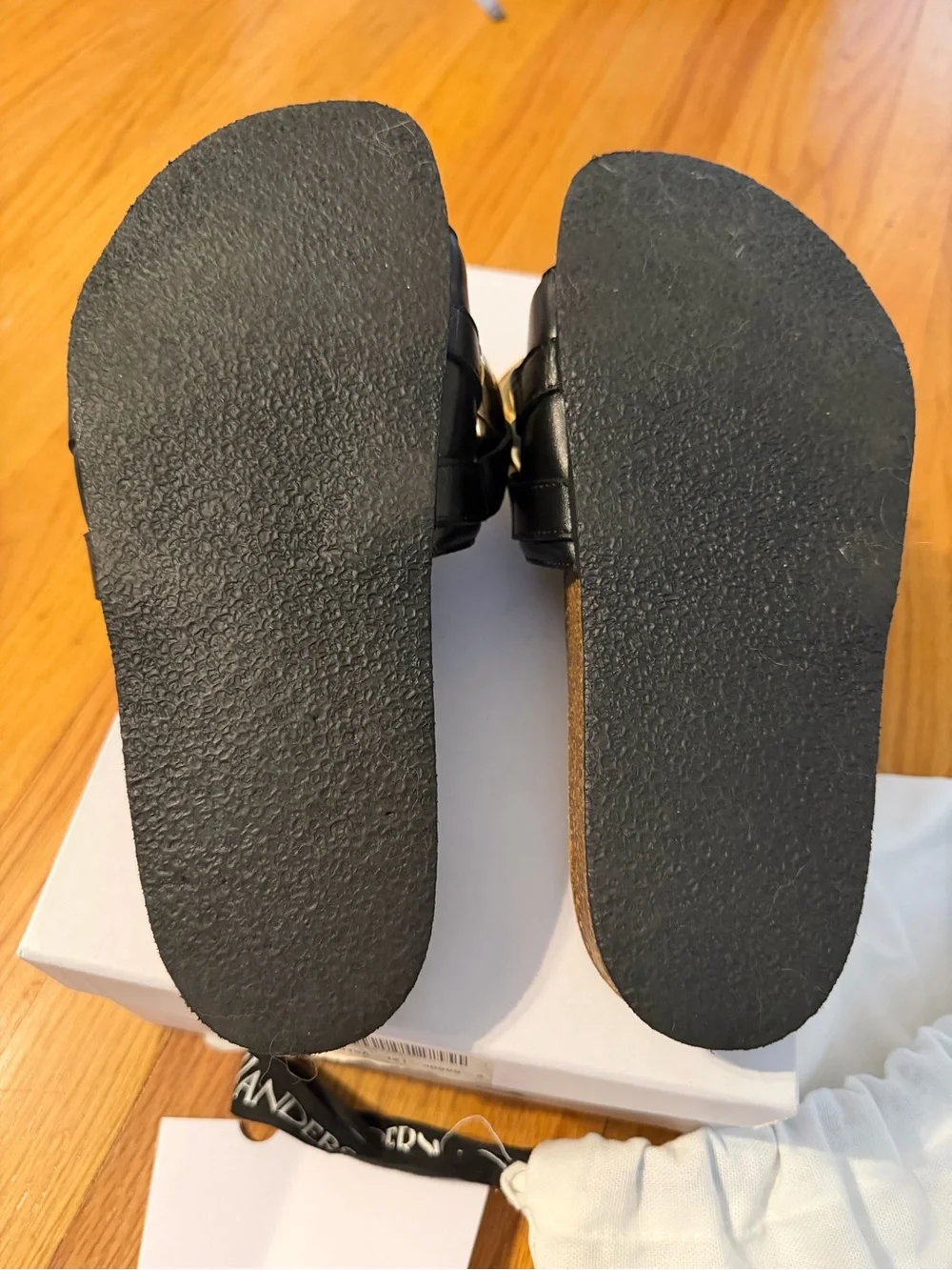 JW Anderson Women’s Black Slide Sandals with Gold Chain Accent